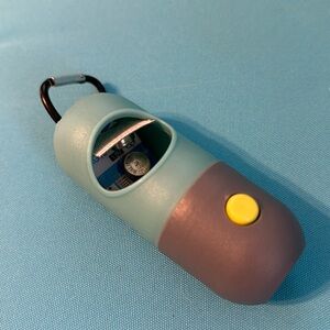 Poop dispenser with built in flashlight